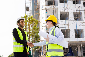 The architect team shake hands and joins in the construction work professionally. Construction business that works with teamwork building construction. Honest cooperation in investing