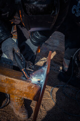 Welder works with metal, robot welder