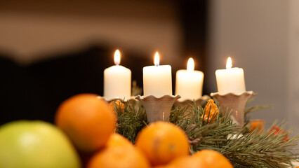 Christmas composition with candle and tangerines