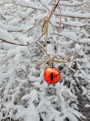 Beautiful Christmas disco ball on branch in Winter Forest. Vertical photo can used Greeting Card Cover and winter web poster. Background with tree in snow for social media and reels.