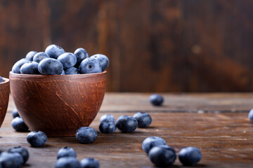 Freshly picked blueberries in  bowl. Bilberry on wooden Background. Blueberry antioxidant. Concept for healthy eating and nutrition