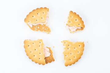 Stacked sandwich biscuits with pink cream filling.