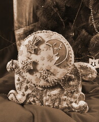 A festive gingerbread on a red tablecloth for a Christmas background. Close up Photo. New Year Banner. Sepia Style