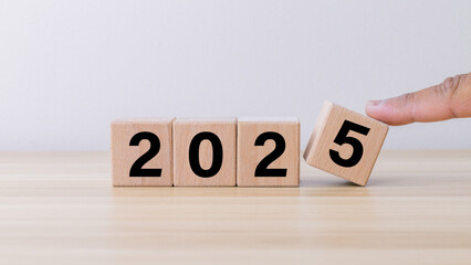 wooden cube year 2025 on wooden table.