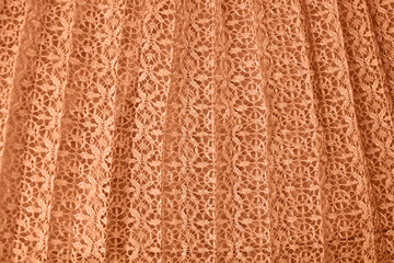 Abstract textile background with a pattern. Peach Fuzz is the trendy color of the year 2024. 