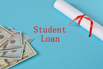 Student education loan concept. Student loan wording on blue background with US dollar banknotes and certificate.