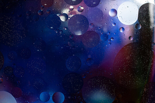 Photo of oil on a water surface with bubbles. Abstract colorful background. Macro close-up, not illustration