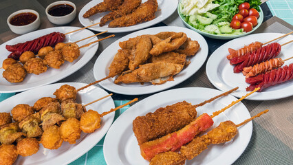 The fried meatballs made from a variety of meats and sausages, mixed with flour and seasonings with a delicious spicy sauce and come with cucumber, cabbage, tomato and lettuce as sides. Street Food.