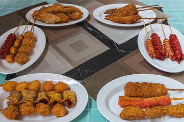 The empty space in the center is for illustrations with fried meatballs made from a variety of meats and sausages and chicken wings, mixed with flour and seasonings around the outside.