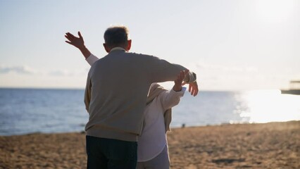 Senior man woman meeting on sandy sea beach spreading arms having strong hugs. Wife husband were separated missed each other. Family wife husband cuddling, embracing. Lifelong marriage love concept.