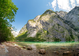 Fototapeta na wymiar The crystal clear water of the Obersee in Berchtesgaden invite to to relax and reload all batteries