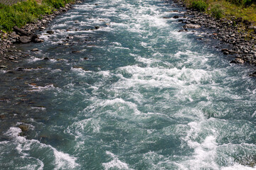 Streams of water from a mountain river, pouring, bubbling and waves