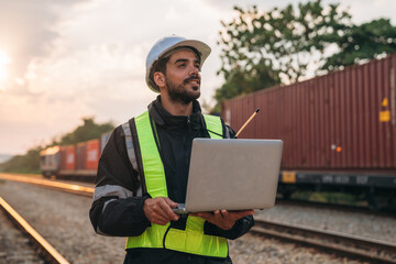 Foreman checking inventory or task details on freight train cars and shipping containers. Logistics concept, import, and export industries. - obrazy, fototapety, plakaty