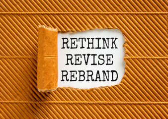 Rethink revise rebrand symbol. Concept word Rethink Revise Rebrand on beautiful white paper. Beautiful brown table background. Business brand motivational rethink revise rebrand concept. Copy space.