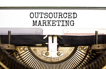 Outsourced marketing symbol. Concept words Outsourced marketing typed on beautiful old retro...