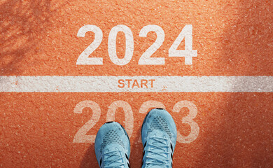 New year 2024 start concept, beginning of success. Text 2024 written on asphalt road runner...