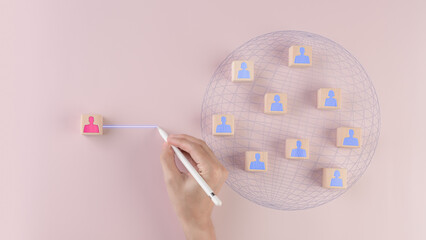 Teamwork concept, management, wooden cube block print screen person icon which link connection network for organisation structure social network ,pink background.