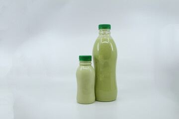 Fresh avocado juice served in bottle isolated on background side view of healthy morning juice drink