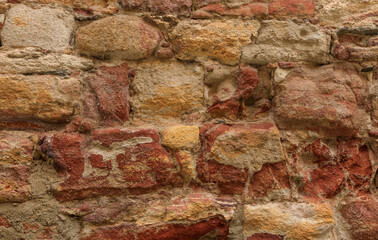 Background of an ancient sandstone wall of many colours