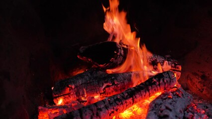 Stone fireplace with burning logs and smoke
