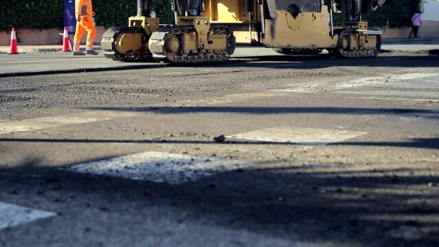 Asphalt milling machine or cold planer Live video. Theme of road construction.