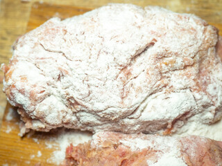 A piece of minced chicken in flour. Meat after the meat grinder. Cooking cutlets. Minced meat close-up.
