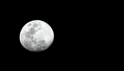 Full detail moon closeup on a black background with stars visible