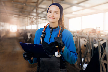 Portrait woman doctor veterinarian with clipboard background milk cow on livestock farm cattle