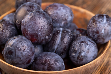 Wet purple plum on the table, fresh harvest