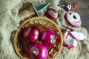 Raw onions, in a composition on an old background