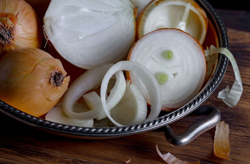 Raw onions, in a composition on an old background