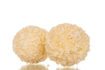 Two candies with nut and coconut flakes, macro, isolated on white background.