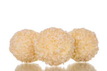 Three candies with nut and coconut flakes, macro, isolated on white background.