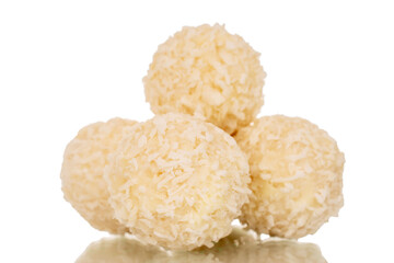 Several candies with nut and coconut flakes, macro, isolated on white background.
