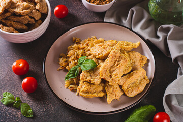 Alternative soy meat with rice on a plate on the table