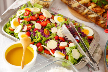 salad tray with various fruits, greens and cold vegetables