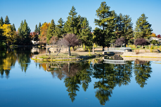 Dramatic image of the man made lake in Marysville, California, with reflections and fall colors in the trees.