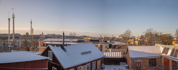 Panorama view from a hill park with old workshop houses and skyline a snowy sunny winter day in...