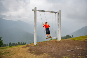 Euphoric Suspension: Man Gliding through the Air in Orange T-Shirt