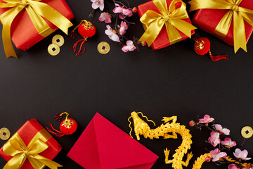 Symbolic presents for Chinese New Year. Top view flat lay of red envelope, present boxes, gold...