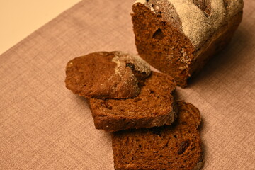 Sliced black bread on a grey background, loaf of black borodish fresh bread, healthy bread 	