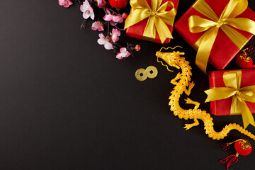 Gift-giving traditions for Chinese New Year. Top view flat lay of gold dragon, present boxes,...
