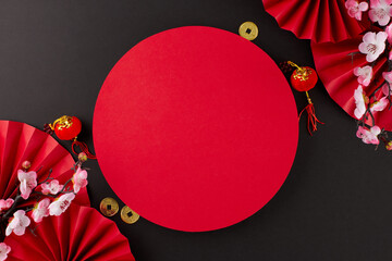 Happy Chinese New Year 2024 idea. Top view flat lay of red paper fans, gold coins, decorative...
