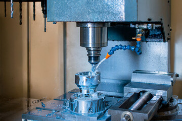 Close-up of a CNC milling machine drilling holes.