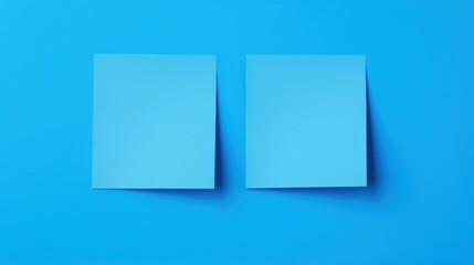 Fototapeta premium two pieces of paper sitting on top of a blue surface with one piece of paper on top of the other.