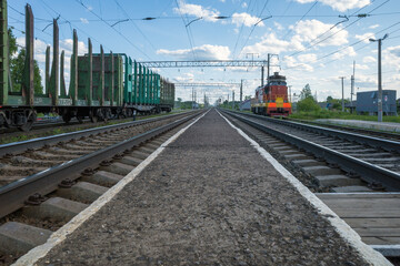 Fototapeta na wymiar railway station with empty freight cars for timber logs