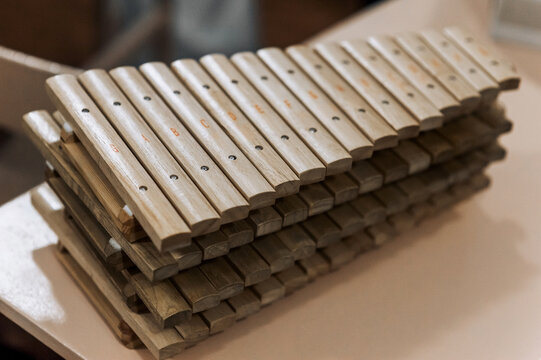 A lot of wooden xylophones, musical instruments lie on the table. Photography, music concept.