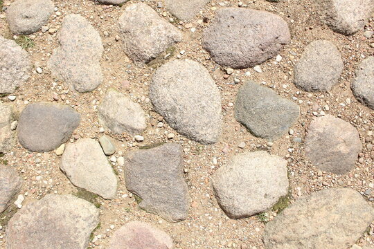 cobblestones, stones frozen with cemet. Background of stones and cobblestones. Brutal background