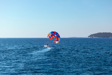 Parasailing in blue sea in the summer vacation . Summertime water sports 