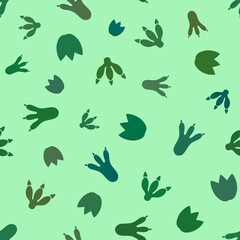 Dinosaur foot prints seamless pattern. Cute dinos children illustration. Isolated on green background © Alena Pershina